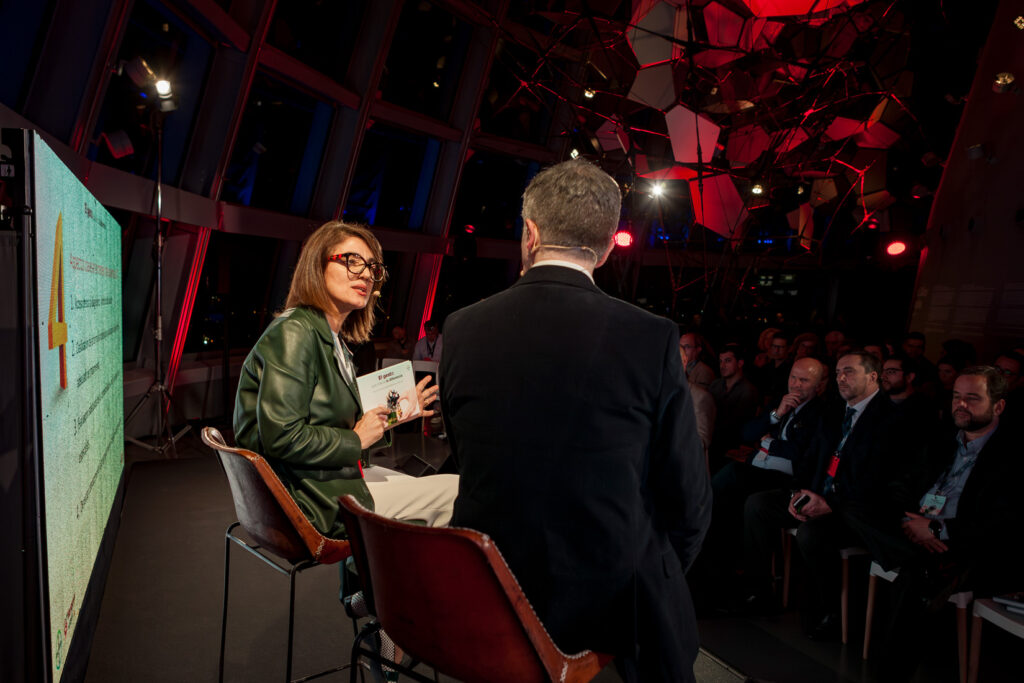 Fotografía de ponencia en evento corporativo con público y escenario